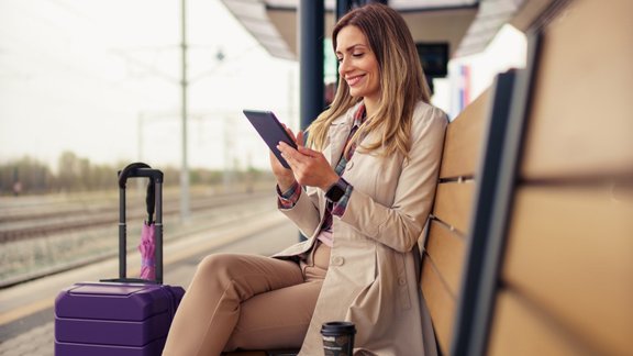 woman,baggage,young,caucasian,wagon,happy,tourism,enjoying,holiday,platform,smile,tourist,holding,alone,modern,public,coffee cup,station,cellphone,vacation,30-40 years,railway,female,train,attractive,suitcase,bench,journey,umbrella,european,one,rail,tired