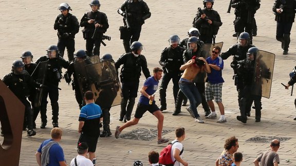 French riot police move in to detain Russian soccer fans 