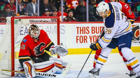 Calgary Flames goalie Chad Johnson, Buffalo Sabres Zemgus Girgensons scores goal 