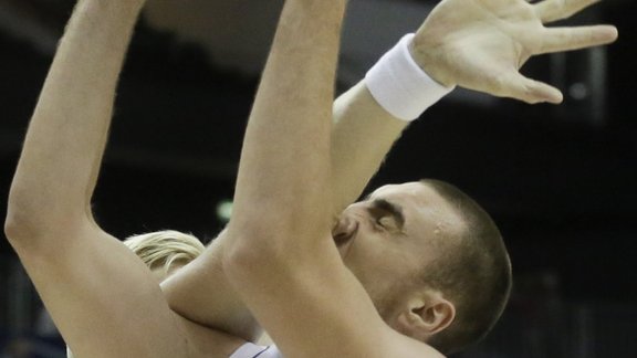 Serbias Nikola Milutinov, right, challenges with Icelands Ragnar Nathanaelsson