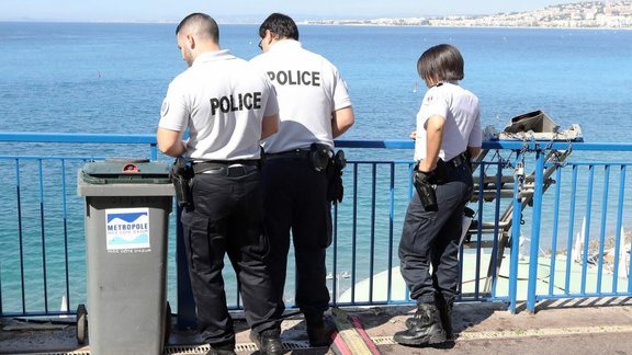 Police watch the site where a football fan fell in Nice