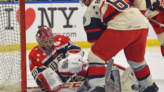 North Division All-Stars goalie Yann Danis, left, attempts to block a shot by Andre Beniot of the Central Division All-Stars 