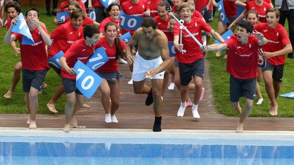 Rafael Nadal of Spain jumps into a swimming pool 