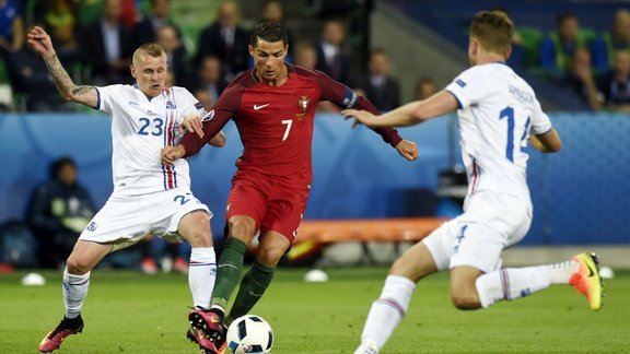 Portugal s forward Cristiano Ronaldo and Iceland defender Ari Skulason