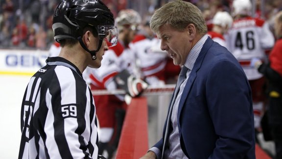 Linesman Steve Barton, Carolina Hurricanes coach Bill Peters 