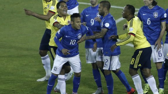 Colombia s Carlos Bacca, second left, pushes Brazil s Neymar,