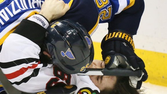 St. Louis Blues Kyle Brodziak with Chicago Blackhawks Andrew Shaw 