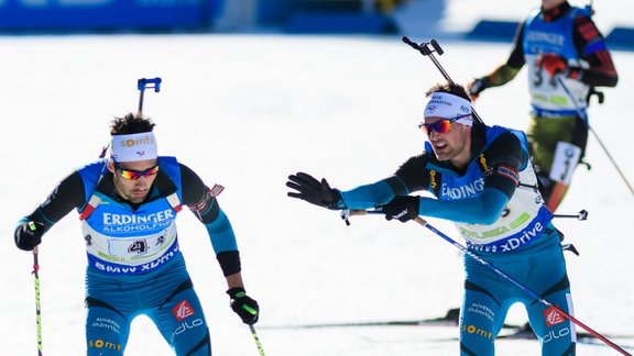 France Simon Desthieux touches his teammate Martin Fourcade