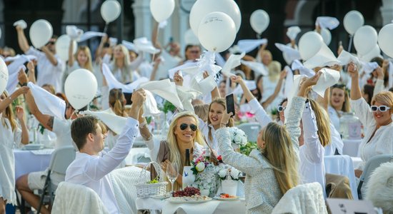 Foto: Spītējot visam, dzīves baudītāji Piņķu 'outlet ciematā' līksmo baltajā piknikā