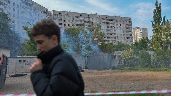 Kharkiv, Ukraine: Residents and creews work to clean and extinguish fires following a Russian strike in the city