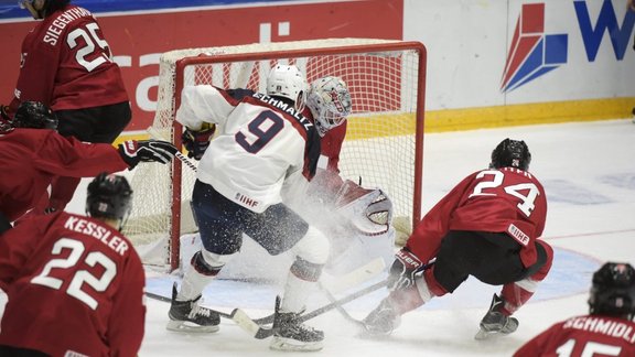 Nick Schmaltz of USA scores goalkeeper Ludovic Waeber of Switzerland