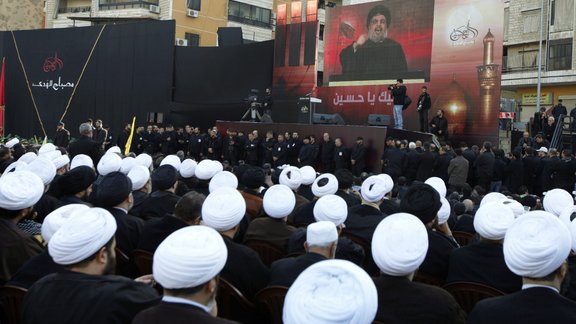 Lebanese Shiite clerics supporters of Hezbollah listen to the speech of Hezbollah leader Hassan 