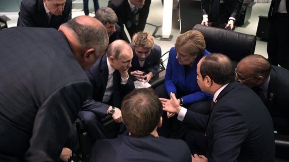 Līvija, Merkela, Putins, Berlīnes konference