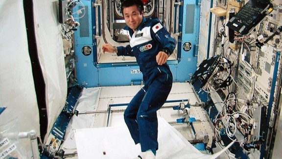 Astronaut demonstrating a "magical flying carpet"