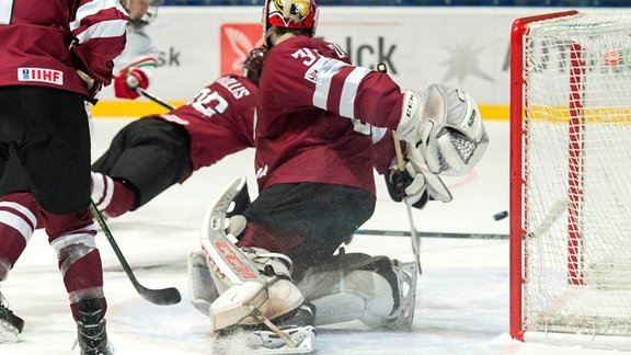 Belarus scores first goal against Latvia Niklavs Rauza #30 during relegation round action at the 2017 IIHF Ice Hockey U18 World Championship