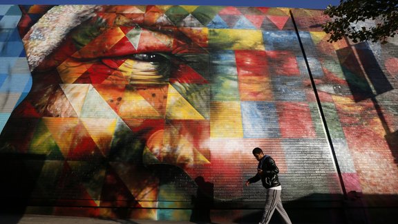 A man walks past a mural of Nelson Mandela painted by Brazilian artist Eduardo Kobra in Los Angeles, California