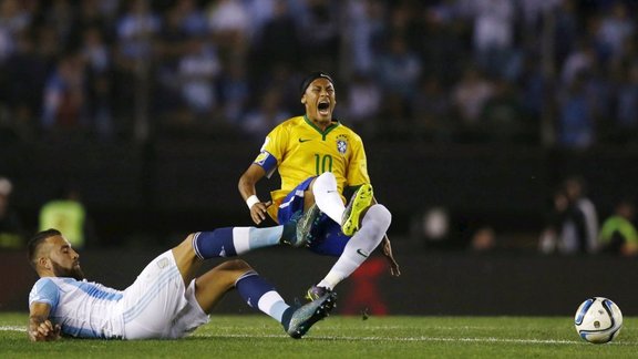 Neymar (R) of Brazil is tackled by Nicolas Otamendi of Argentina 