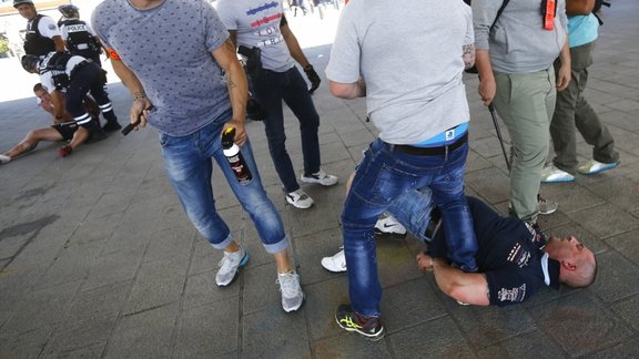 Poland fans are detained by police at Marseille