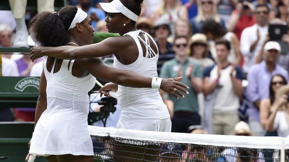 Serena Williams of the U.S.A. embraces Venus Williams