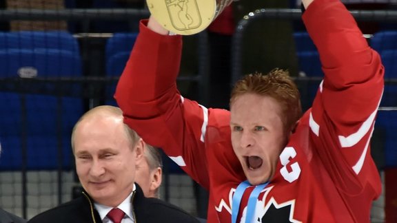 Canada forward Corey Perry celebrates with Russian President Vladimir Putin