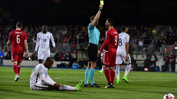 Luxembourg Daniel Da Mota receives yellow card from Andris Treimanis