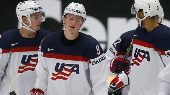 Jack Eichel (№9) celebrates with Mike Reilly (L) and Seth Jones scoring a goal against Slovenia