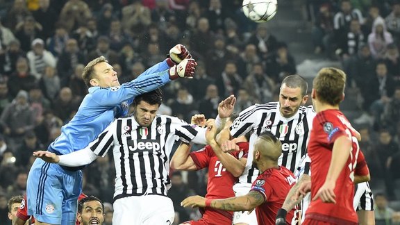 Bayern goalkeeper Neuer blocks a shot by Juventus forward Alvaro Morata