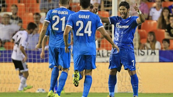 Zenit s Hulk, right, celebrates with teammates Ezequiel Garay, center, and Javi Garcia,